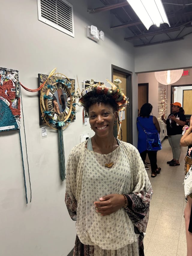 Boston's mom smiling at an art exhibition